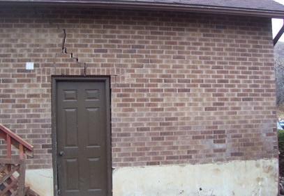 Cracked wall above exterior door