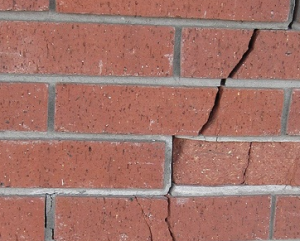 Cracked red brick wall