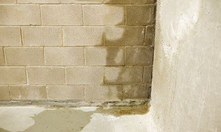 Moisture seeping through cinder blocks causing interior water damage