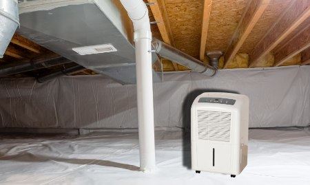 Close-up of a crawl space dehumidifier with humidity controls and air filtration features.