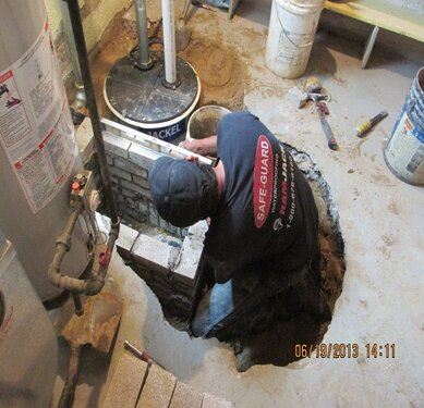 tech installing sewer backup prevention
